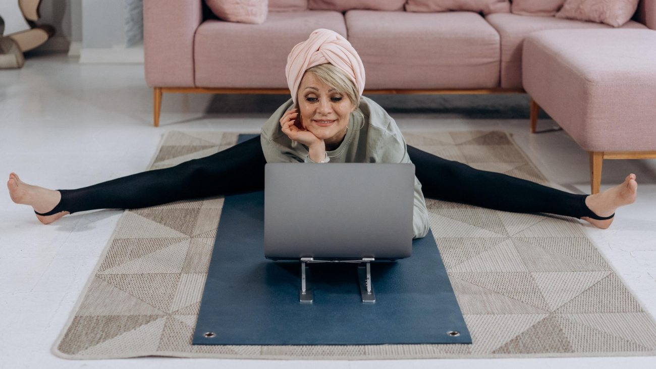 women teaching yoga from her computer