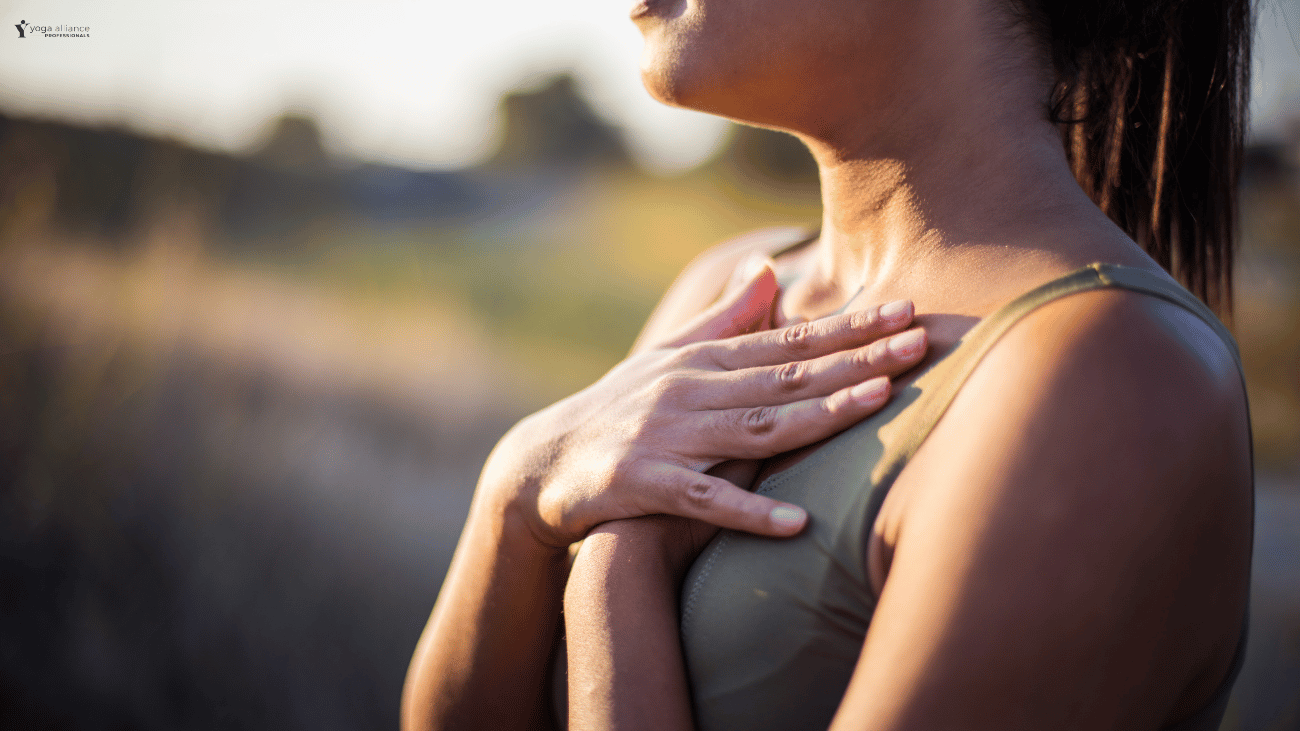 Woman holding hand over her heart